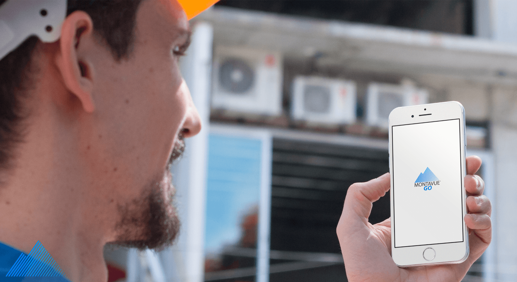 Construction worker holding iPhone with MontavueGO app