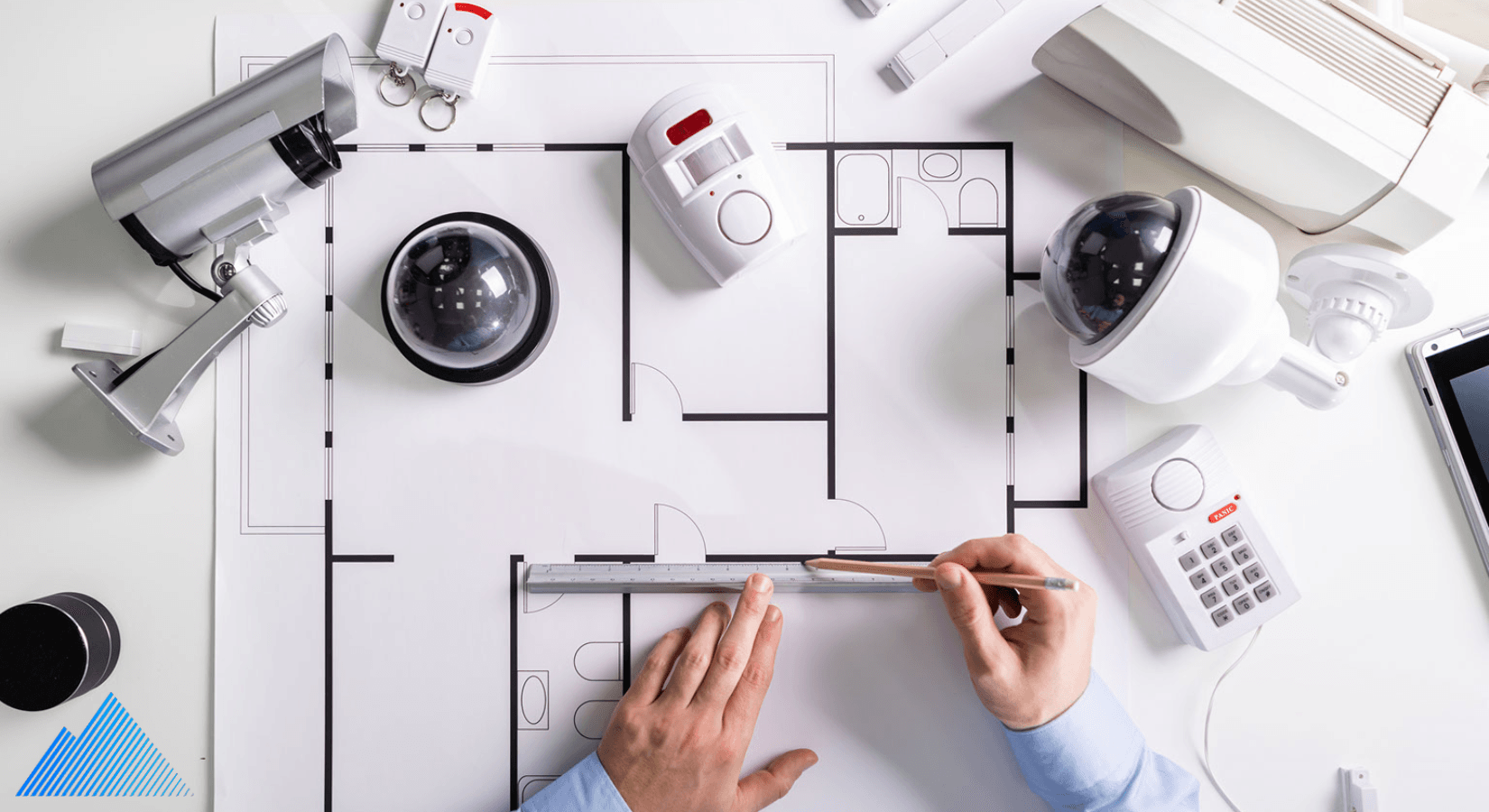 Security cameras and accessories laying on building plan