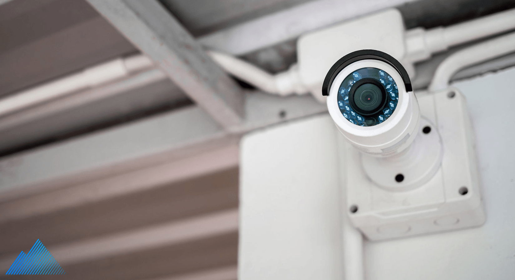 Security camera mounted to the wall with a junction box