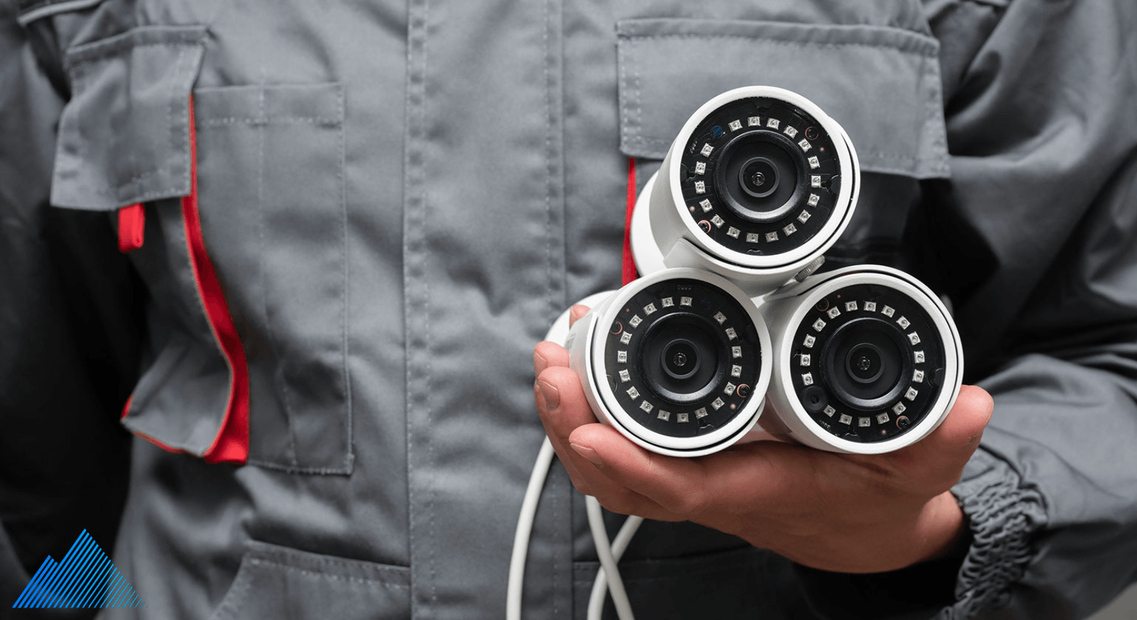 installer holding 3 security cameras