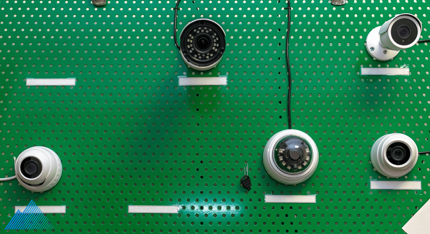 Different types of security cameras mounted to a peg board