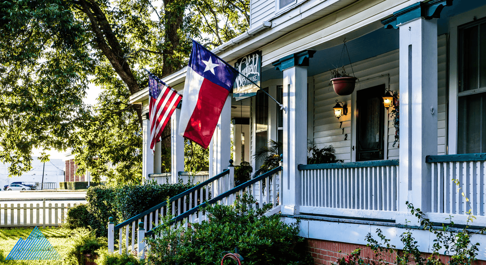 Home with Texas and American flags hanging outside