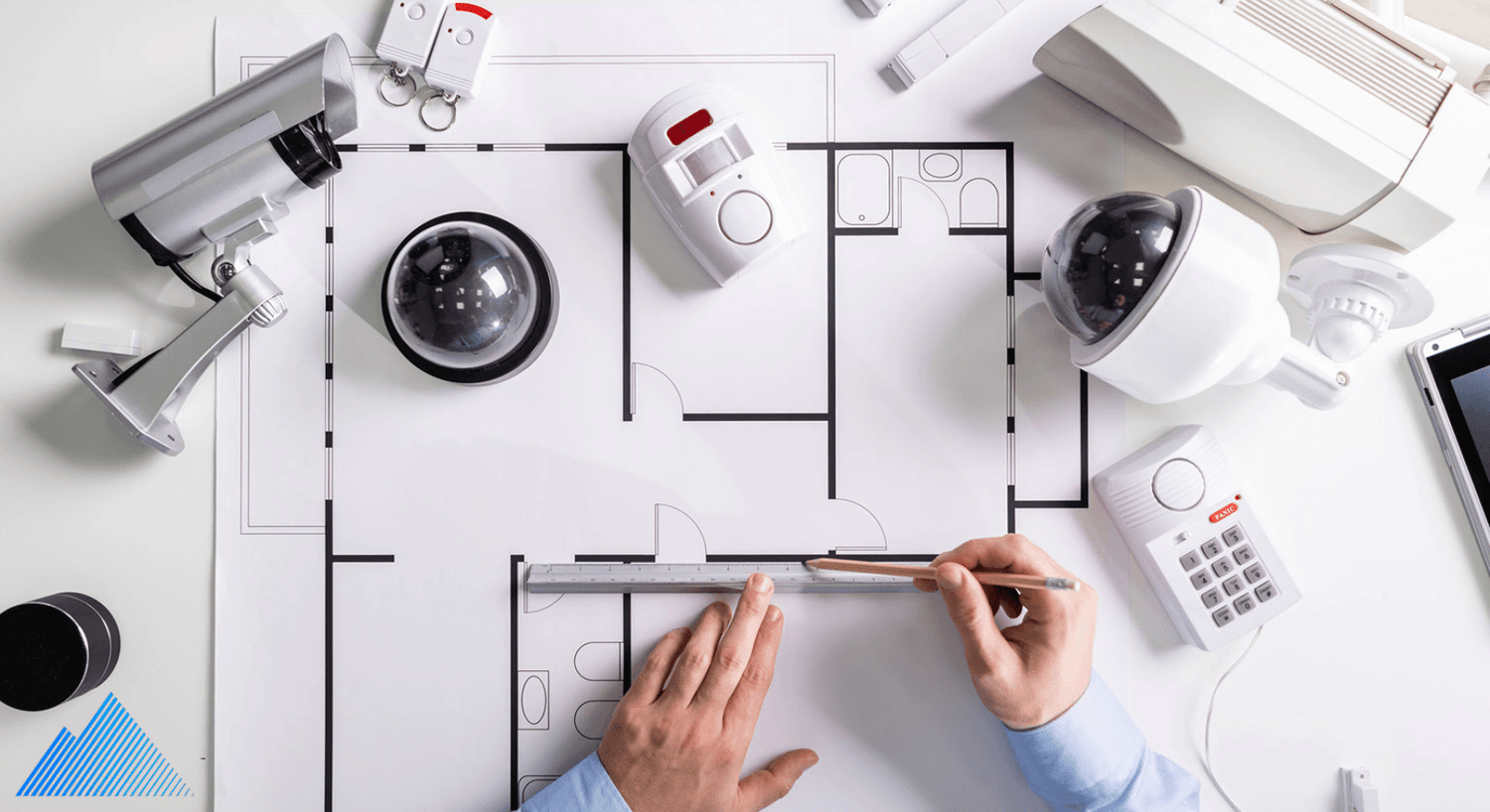 Security cameras and accessories laying on building plan