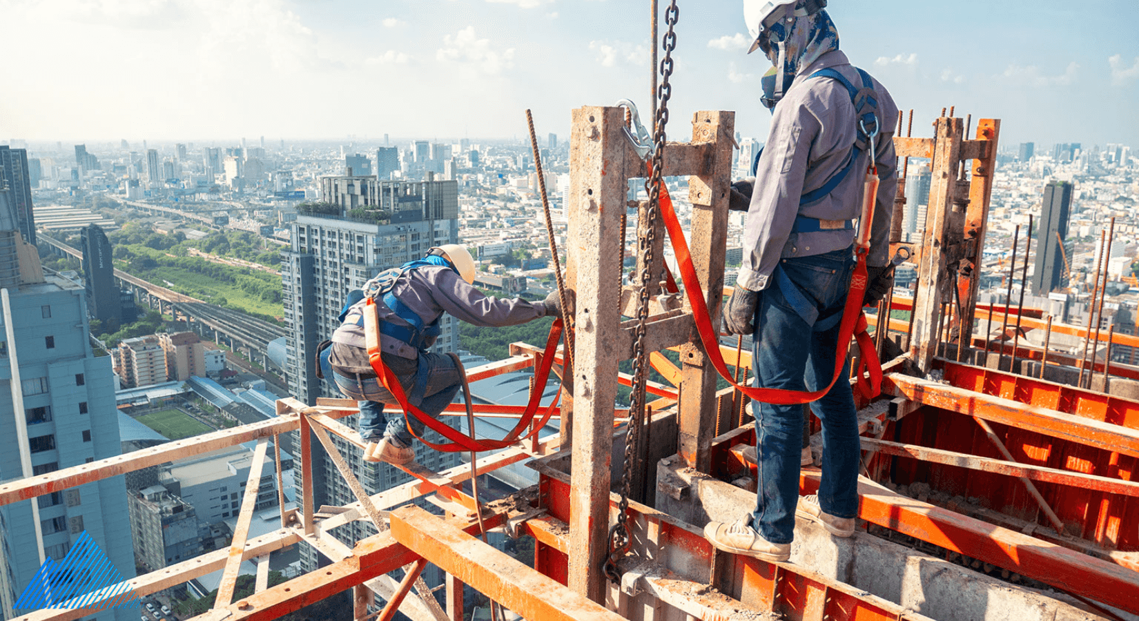 Two construction workers tethered into a sky scraper construction site
